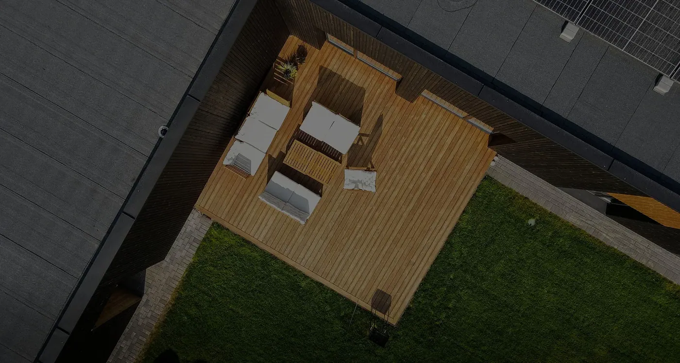 Aerial view of a timber deck with outdoor furniture, built next to a house and lawn